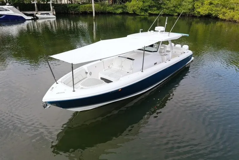 Slide: The Image of 2022 Intrepid 407 Panacea boat with canopy on calm water. - 165