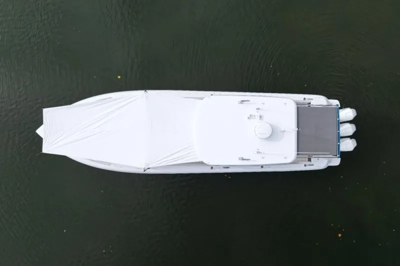 Slide: The Image of Aerial view of 2022 Intrepid 407 Panacea boat on water, covered with a white tarp. - 167