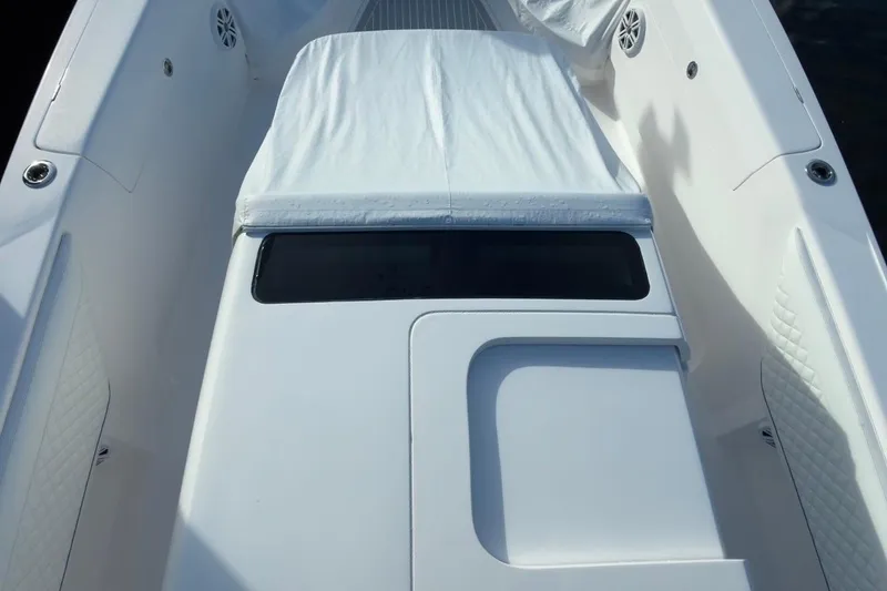 Slide: The Image of 2022 Intrepid 407 Panacea boat interior with cushioned seating and sleek design. - 21
