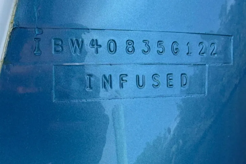Slide: The Image of 2022 Intrepid 407 Panacea hull identification number on blue surface. - 28