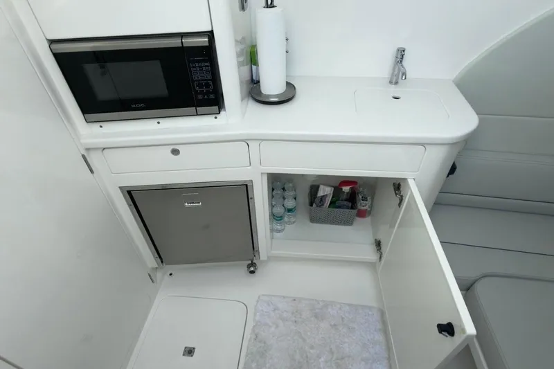 Slide: The Image of 2022 Intrepid 407 Panacea interior with microwave, sink, and storage cabinet. - 34