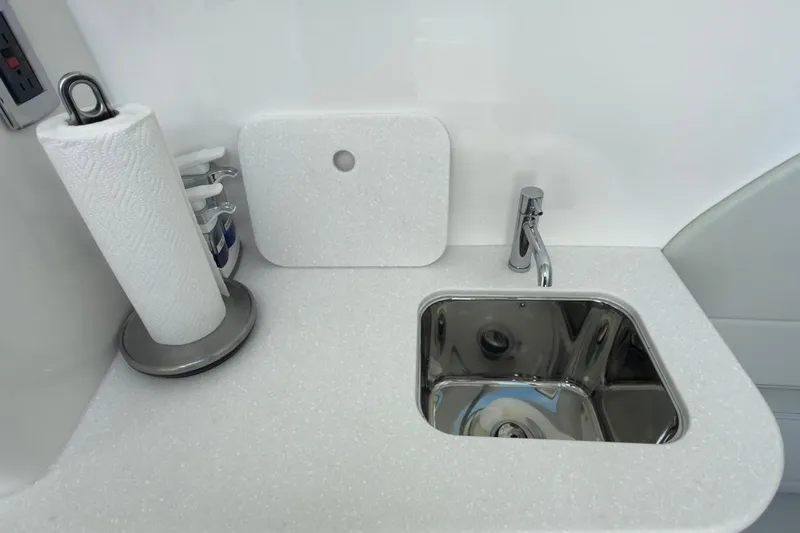 Slide: The Image of Modern sink area in 2022 Intrepid 407 Panacea boat, featuring sleek faucet and paper towel holder. - 37