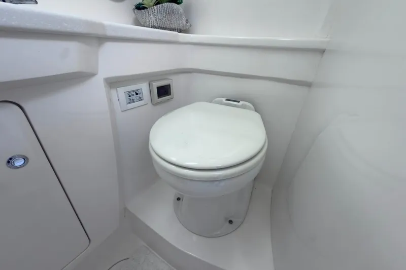 Slide: The Image of 2022 Intrepid 407 Panacea boat bathroom with modern white toilet and sleek design. - 39