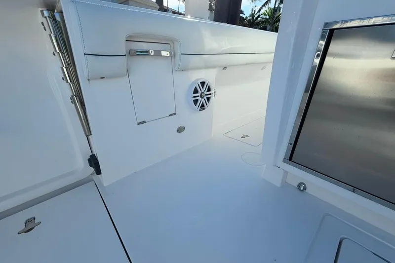 Slide: The Image of 2022 Intrepid 407 Panacea boat interior with sleek white design and stainless steel accents. - 57