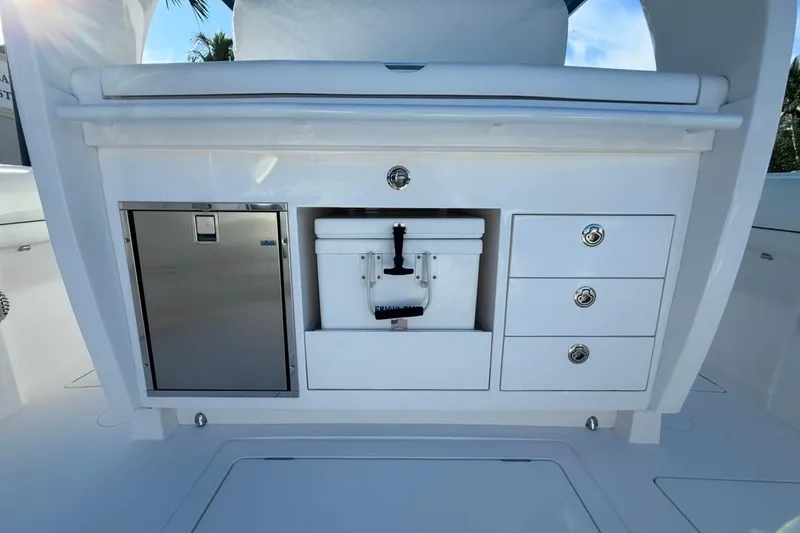 Slide: The Image of 2022 Intrepid 407 Panacea boat interior with storage drawers and cooler. - 59