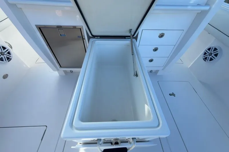 Slide: The Image of 2022 Intrepid 407 Panacea boat interior with open storage compartment and sleek design. - 62