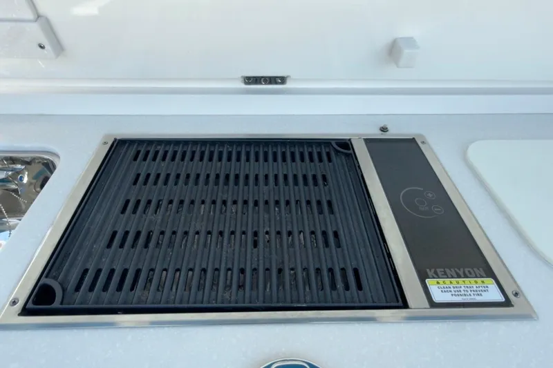 Slide: The Image of Kenyon grill on 2022 Intrepid 407 Panacea boat, featuring sleek design and functionality. - 66