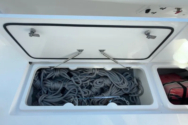 Slide: The Image of Open storage compartment on 2022 Intrepid 407 Panacea boat, containing coiled ropes. - 67