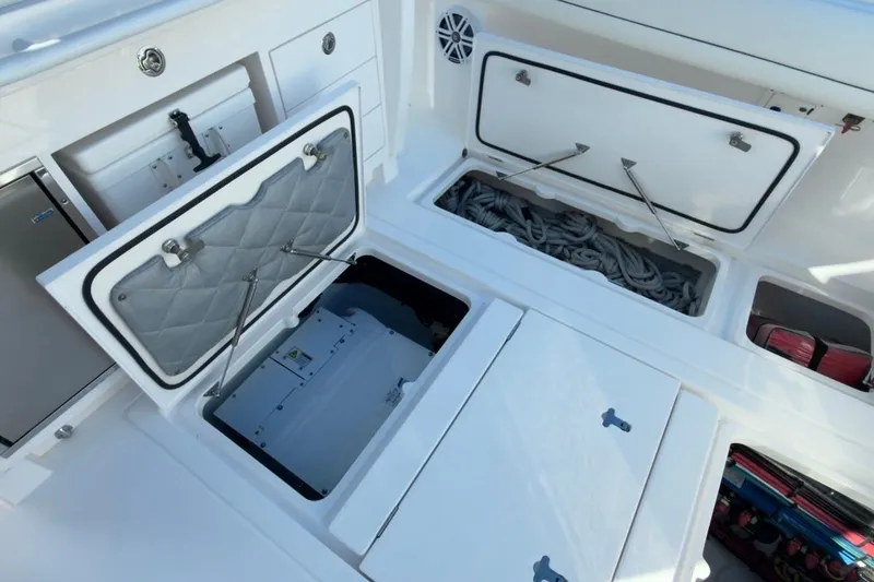 Slide: The Image of 2022 Intrepid 407 Panacea boat storage compartments with open hatches and visible equipment. - 68