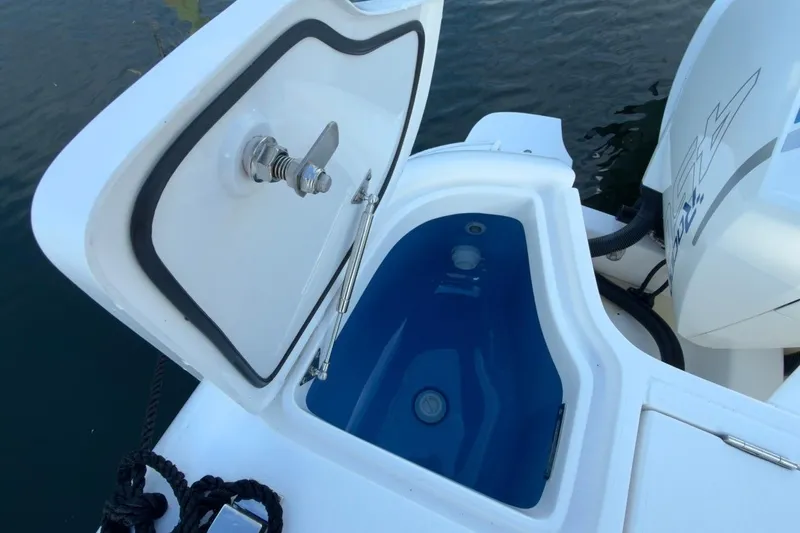 Slide: The Image of 2022 Intrepid 407 Panacea boat with open storage compartment near water. - 69