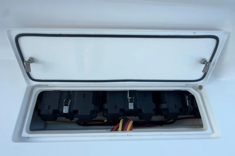 Slide: The Image of Battery compartment of 2022 Intrepid 407 Panacea boat, featuring secure latches and wiring. - 70