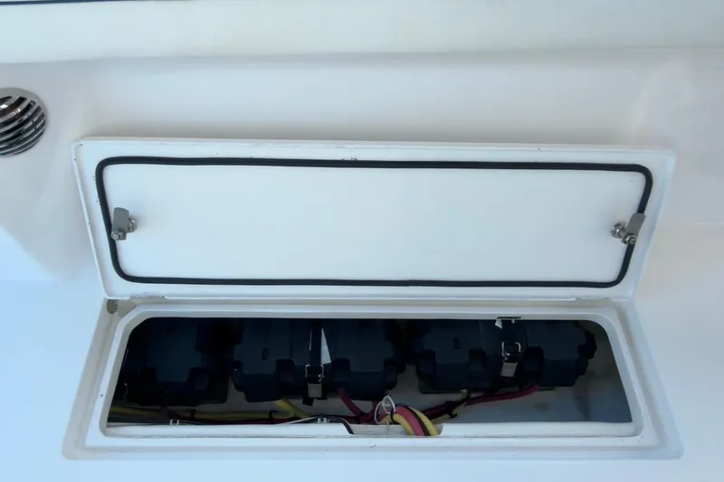 Slide: The Image of Open storage compartment on 2022 Intrepid 407 Panacea boat, showing electrical components. - 71
