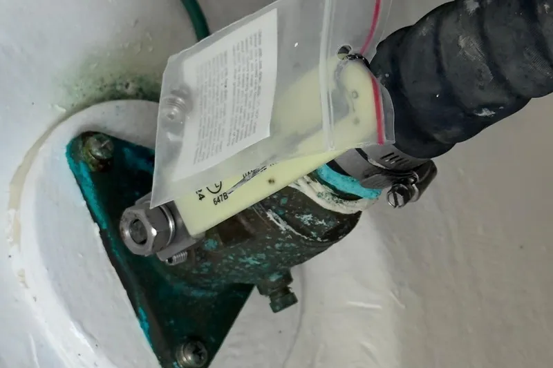 Slide: The Image of Close-up of a 2022 Intrepid 407 Panacea boat component with hose and clamp. - 77