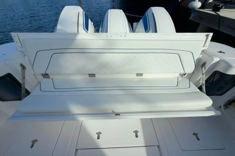 Slide: The Image of 2022 Intrepid 407 Panacea boat with open storage compartment, showcasing sleek design. - 84
