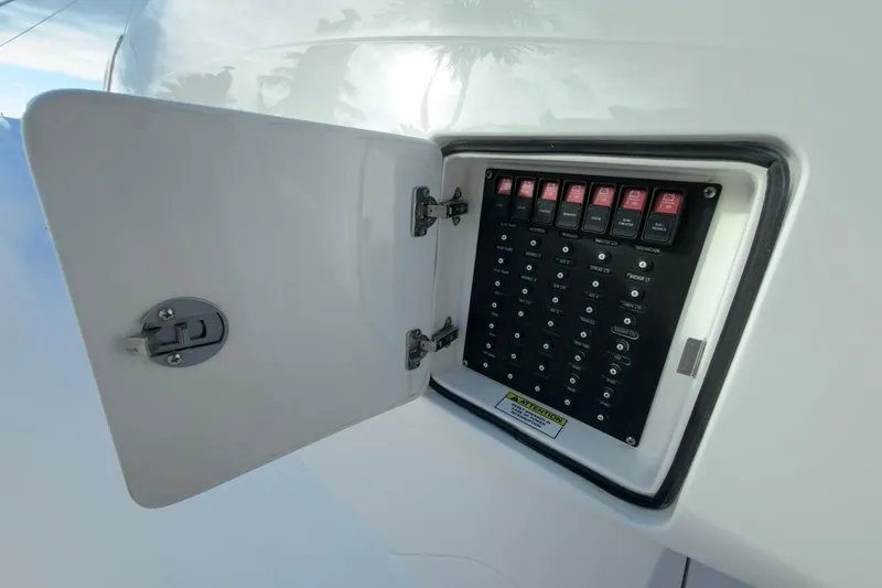 Slide: The Image of Electrical panel on 2022 Intrepid 407 Panacea boat with open access door. - 85