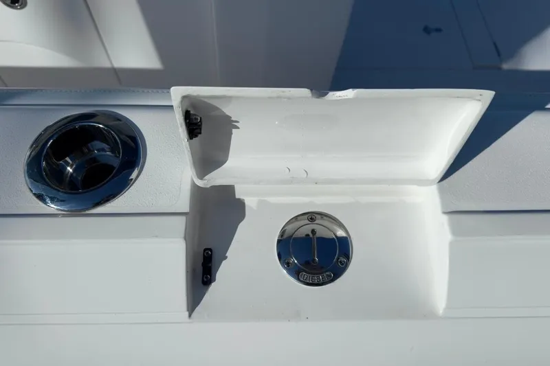 Slide: The Image of Fuel compartment and cup holder on 2022 Intrepid 407 Panacea boat. - 87