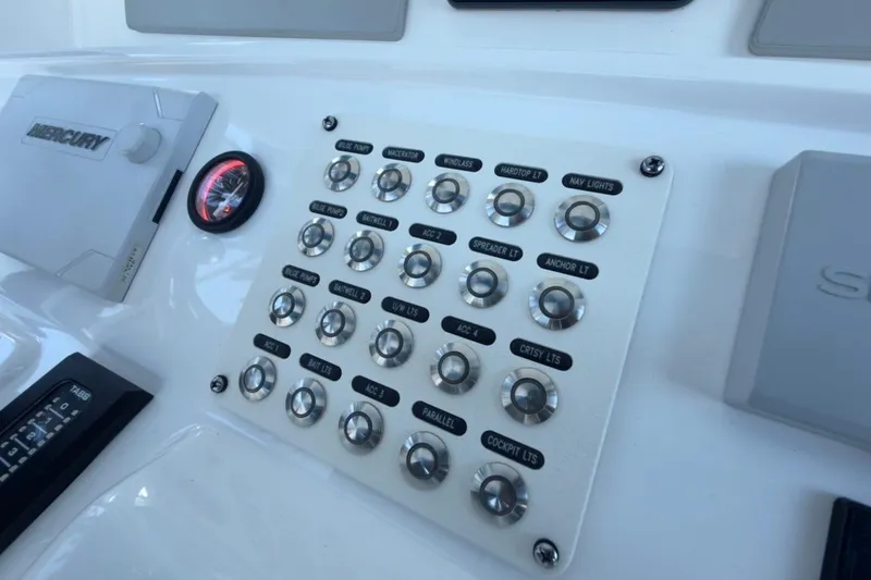 Slide: The Image of Control panel of a 2022 Intrepid 407 Panacea boat with labeled switches. - 93