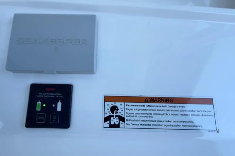 Slide: The Image of Seakeeper control panel and carbon monoxide warning on 2022 Intrepid 407 Panacea boat. - 94