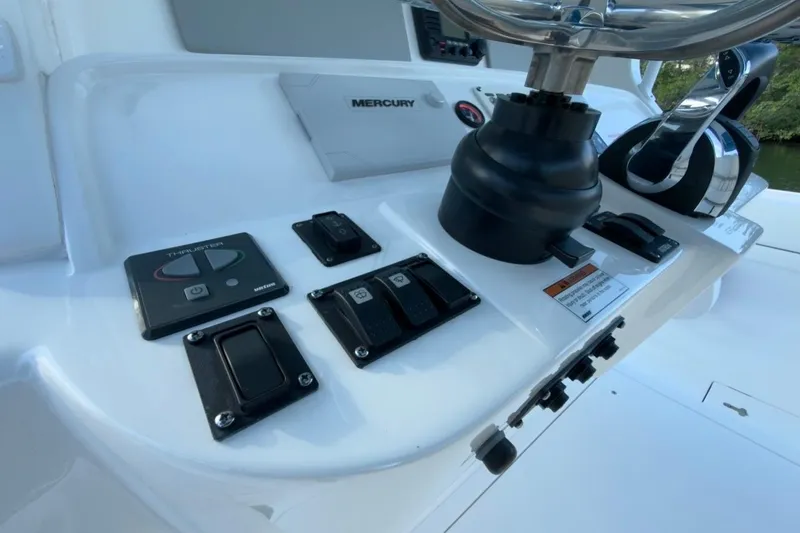Slide: The Image of Control panel of 2022 Intrepid 407 Panacea boat with Mercury throttle and switches. - 96