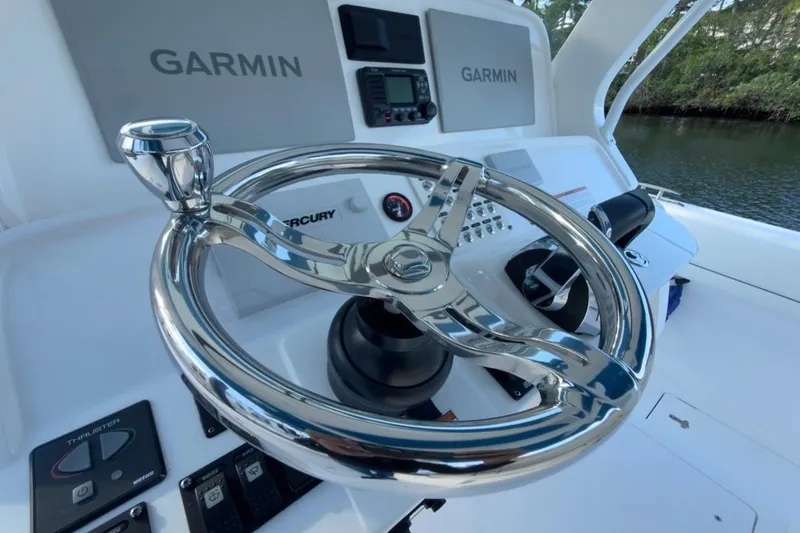 Slide: The Image of Steering wheel and controls of 2022 Intrepid 407 Panacea boat with Garmin displays. - 97