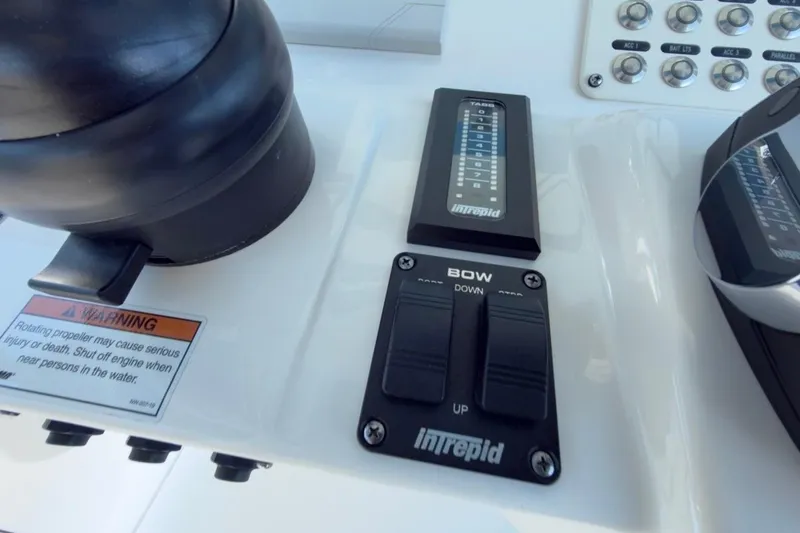 Slide: The Image of Control panel of 2022 Intrepid 407 Panacea boat with warning label and switches. - 98