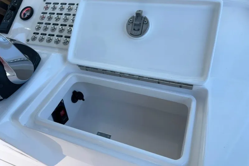 Slide: The Image of Control panel and storage compartment on 2022 Intrepid 407 Panacea boat. - 99