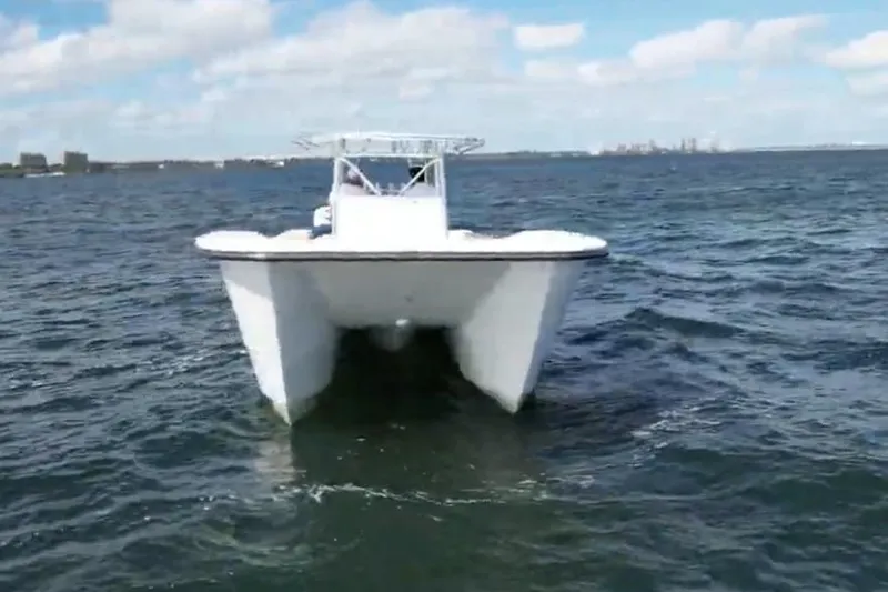 Slide: The Image of 2025 AmeraCat 39 catamaran cruising on open water under a clear sky. - 10