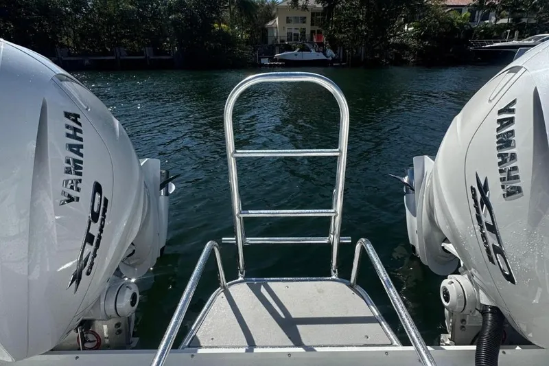 Slide: The Image of 2025 AmeraCat 39 boat with Yamaha engines, docked by a serene waterfront. - 8