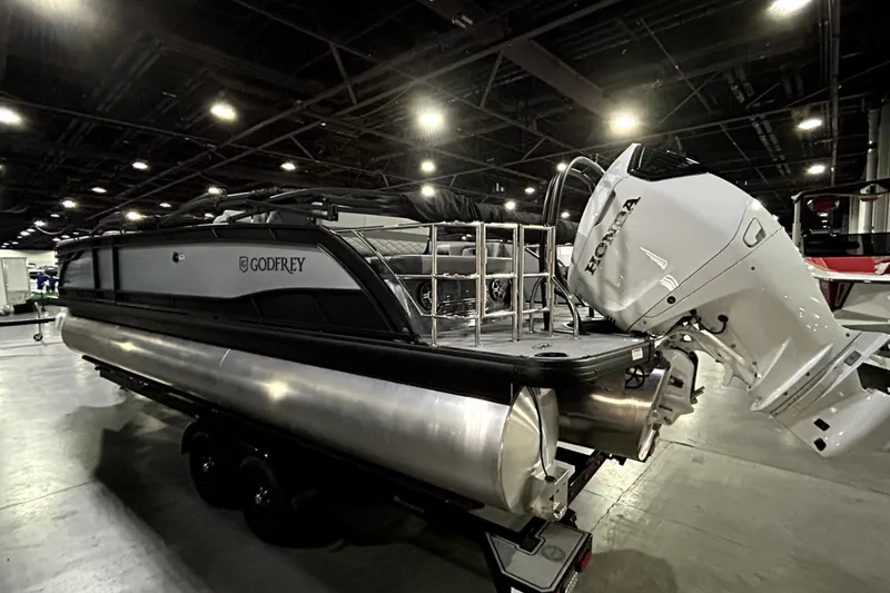 Slide: The Image of 2026 Godfrey Monaco 255 QSL pontoon boat with Honda outboard motor in showroom. - 3