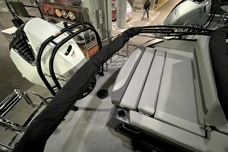 Slide: The Image of 2026 Godfrey Monaco 255 QSL boat interior with seating and engine view. - 6