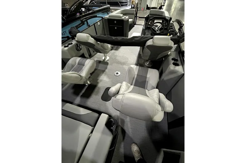 Slide: The Image of Interior of 2026 Godfrey Monaco 255 QSL boat with modern seating and steering console. - 7