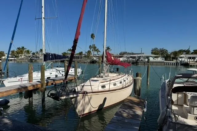 The Image of 1989 Island Packet 35 sailboat docked in a sunny marina with clear blue skies. - 0