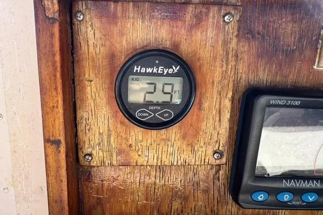 Slide: The Image of Depth gauge and wind instrument on 1989 Island Packet 35 sailboat dashboard. - 14