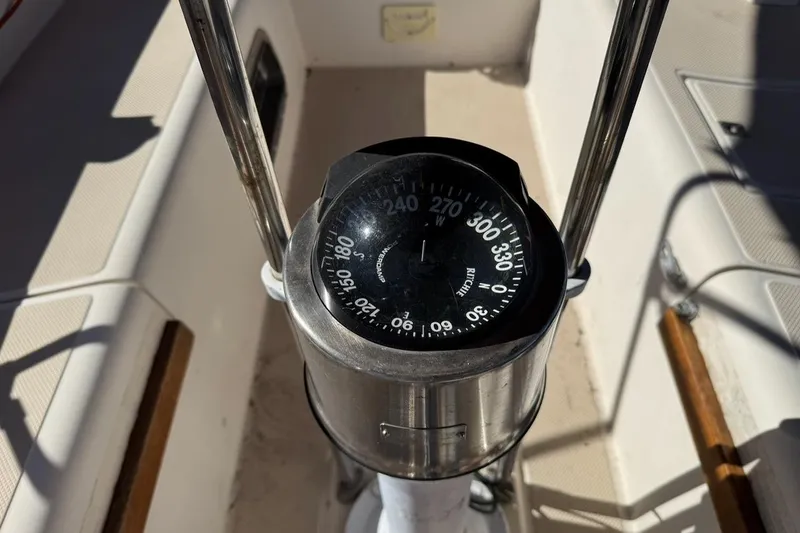 Slide: The Image of Compass on 1989 Island Packet 35 sailboat, showing navigation directions. - 16