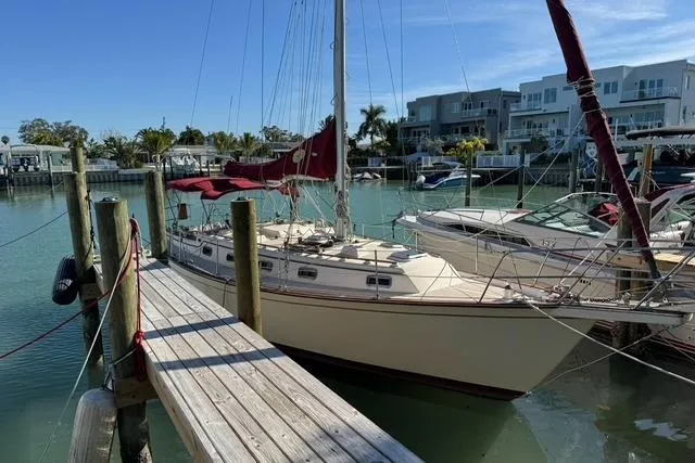 Slide: The Image of 1989 Island Packet 35 sailboat docked in a sunny marina. - 2