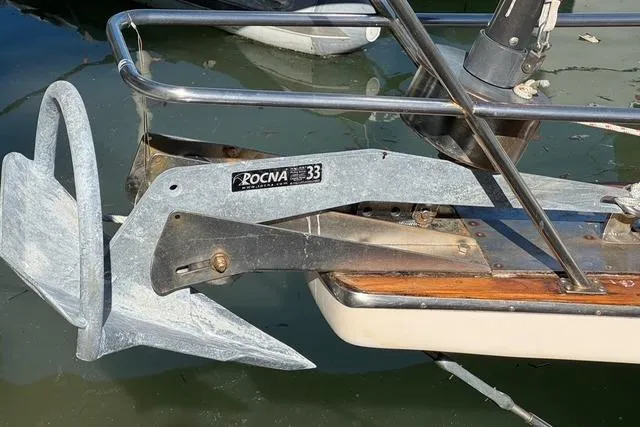 Slide: The Image of Rocna 33 anchor on 1989 Island Packet 35 sailboat, docked in calm water. - 22