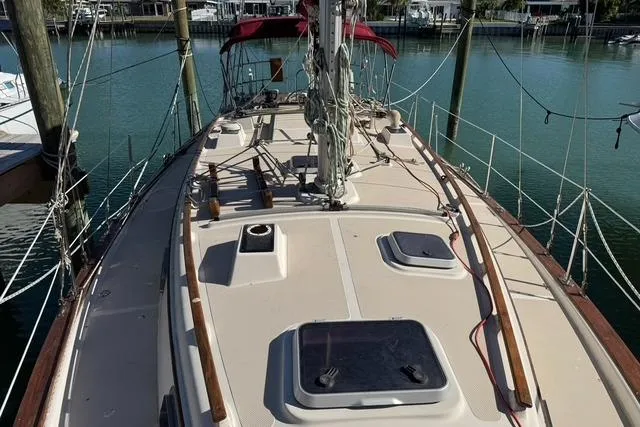 Slide: The Image of 1989 Island Packet 35 sailboat deck view at marina, showcasing rigging and hatches. - 3