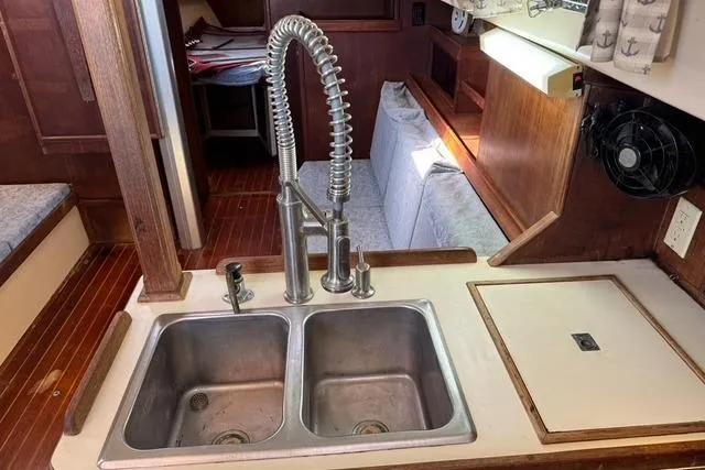 Slide: The Image of 1989 Island Packet 35 yacht interior with dual sink and wooden cabinetry. - 30