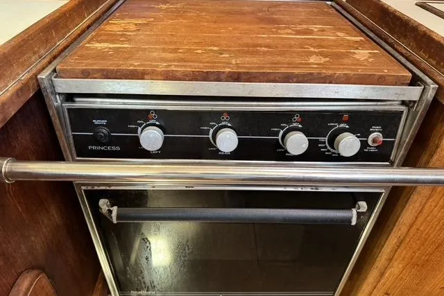 Slide: The Image of 1989 Island Packet 35 yacht kitchen with Princess stove and oven, featuring wooden countertop. - 31