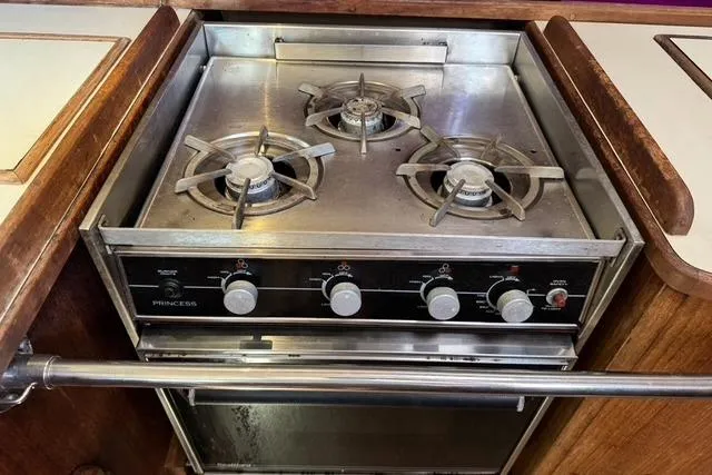 Slide: The Image of Three-burner stove and oven in 1989 Island Packet 35 yacht kitchen. - 32