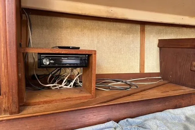 Slide: The Image of 1989 Island Packet 35 interior with Pioneer stereo and visible wiring. - 50