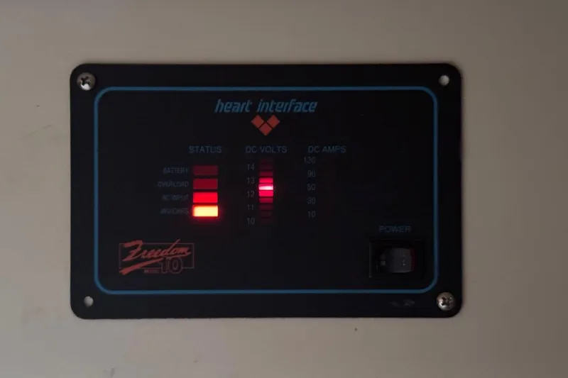 Slide: The Image of Control panel of a 1989 Island Packet 35 boat, displaying battery and power status. - 58