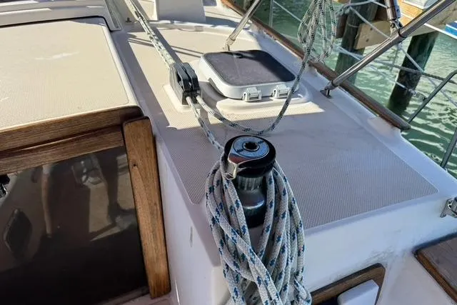 Slide: The Image of 1989 Island Packet 35 sailboat deck with winch and ropes, showcasing nautical equipment. - 9