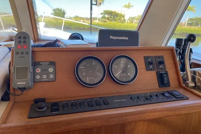 Slide: The Image of 1999 Mainship 350 Trawler dashboard with Raymarine navigation and control instruments. - 15