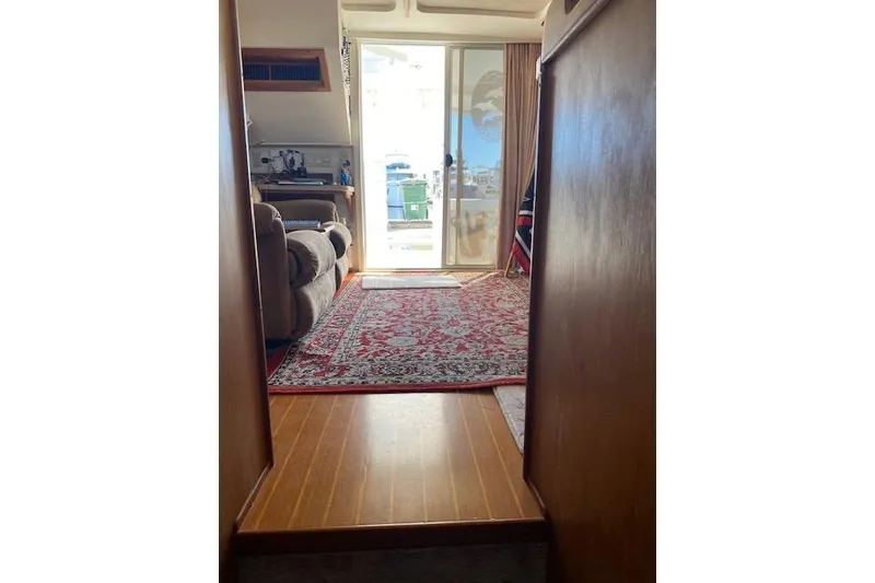 Slide: The Image of Interior view of 1999 Mainship 350 Trawler with carpet and sliding glass door. - 18