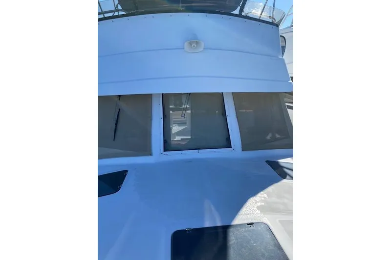 Slide: The Image of 1999 Mainship 350 Trawler front view with windows and deck details. - 24