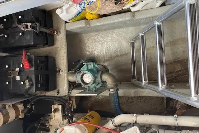 Slide: The Image of Engine room of 1999 Mainship 350 Trawler with batteries and pump system. - 31