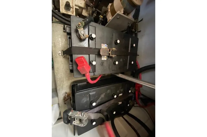 Slide: The Image of Battery compartment of a 1999 Mainship 350 Trawler with visible wiring and connections. - 33