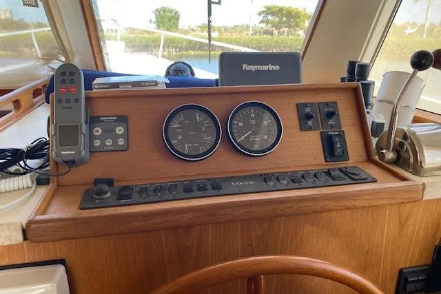 Slide: The Image of 1999 Mainship 350 Trawler helm with Raymarine navigation and control panel. - 37