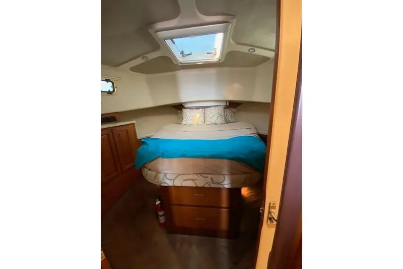 Slide: The Image of Cozy cabin interior of 1999 Mainship 350 Trawler with skylight and comfortable bedding. - 44